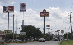 Neighboring fast food restaurant advertisement signs in Bowling Green, Kentucky