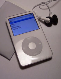 A white Fifth Generation iPod (iPod Video) with a case and earbuds.