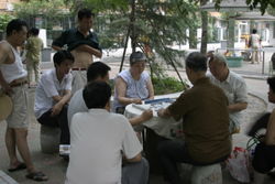 Beijing residents playing Mahjong in public.